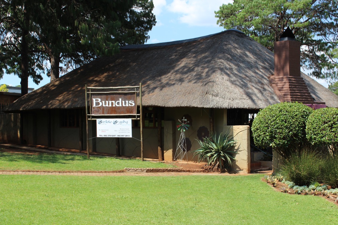 Bundus, a thatched building on the lawns at The Pines